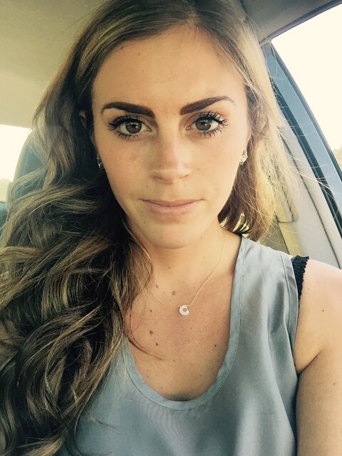 girl in car selfie straight forward showcasing benefit mascara